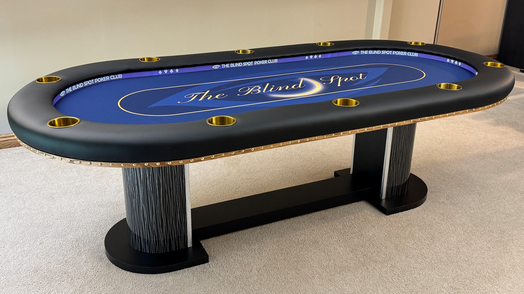 Blind Spot Custom Poker Table custom poker table featuring led lights, a casino laminate table base and a blue custom cloth featuring an eye ball