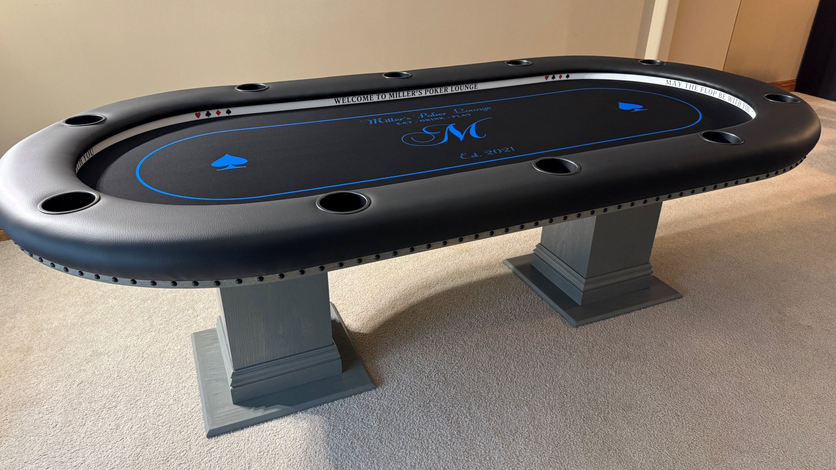 Grey custom poker table Grey custom poker table with a black & blue custom cloth and led lights.