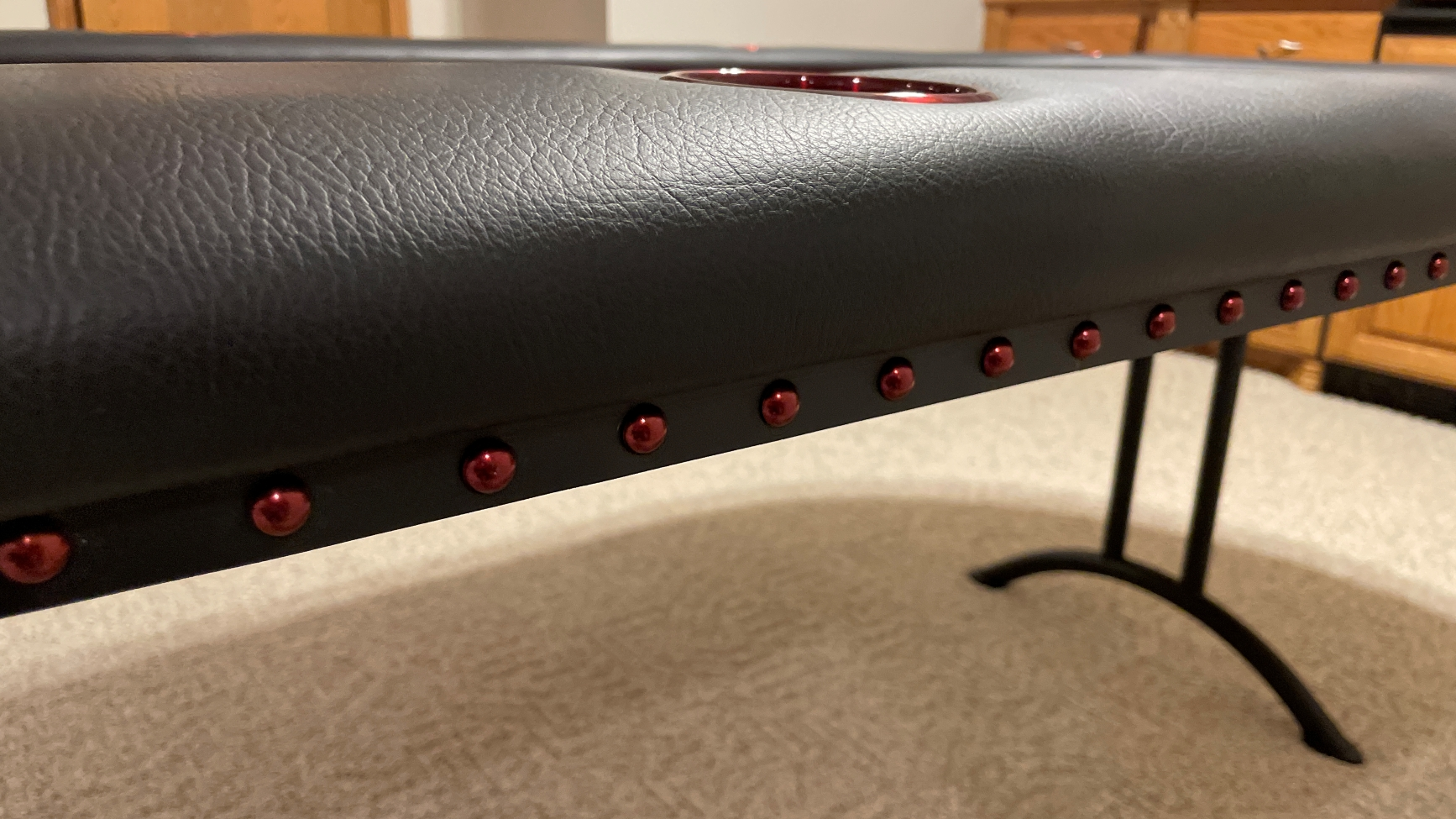 Red Deco Nail Heads poker table with black edge banding and red deco nail heads